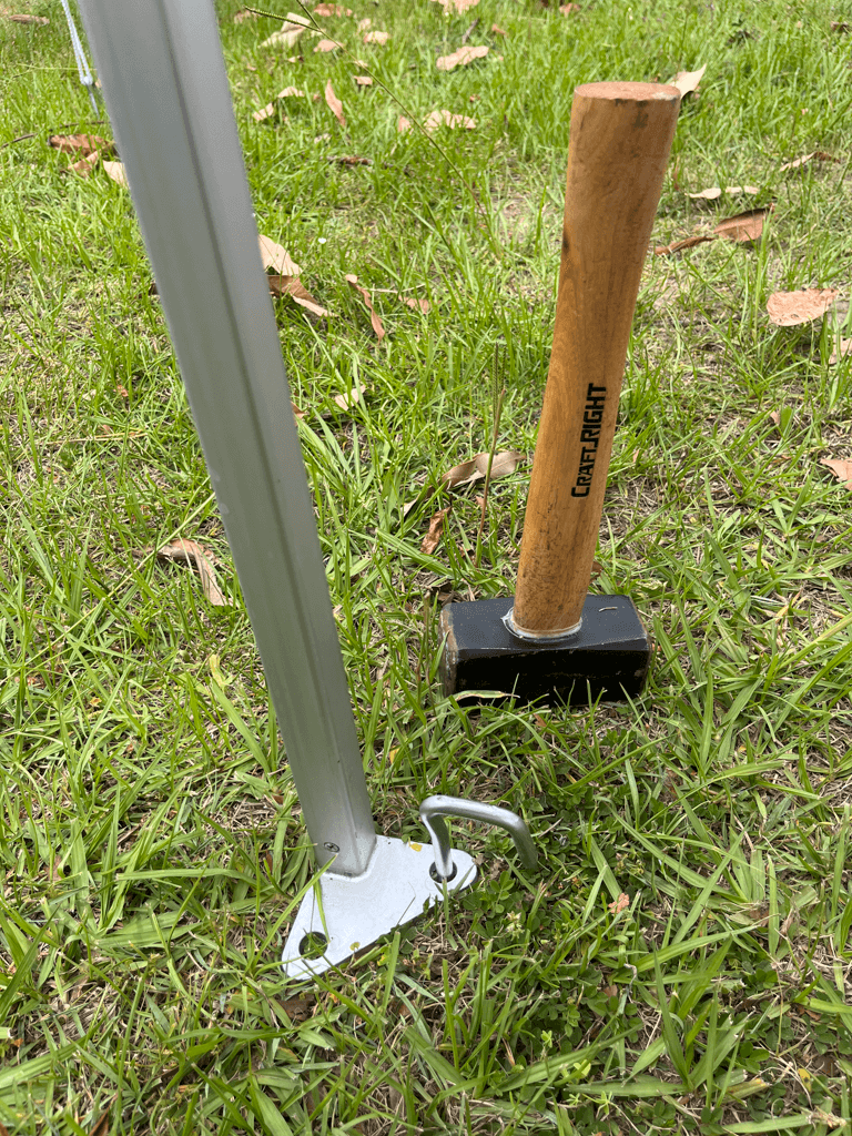 A peg hammered through the foot of a marquee leg